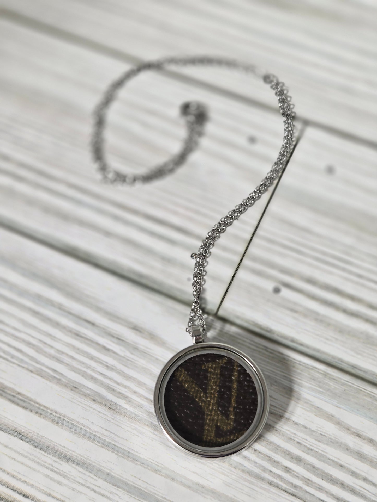 Upcycled stainless steel pendant and chain.