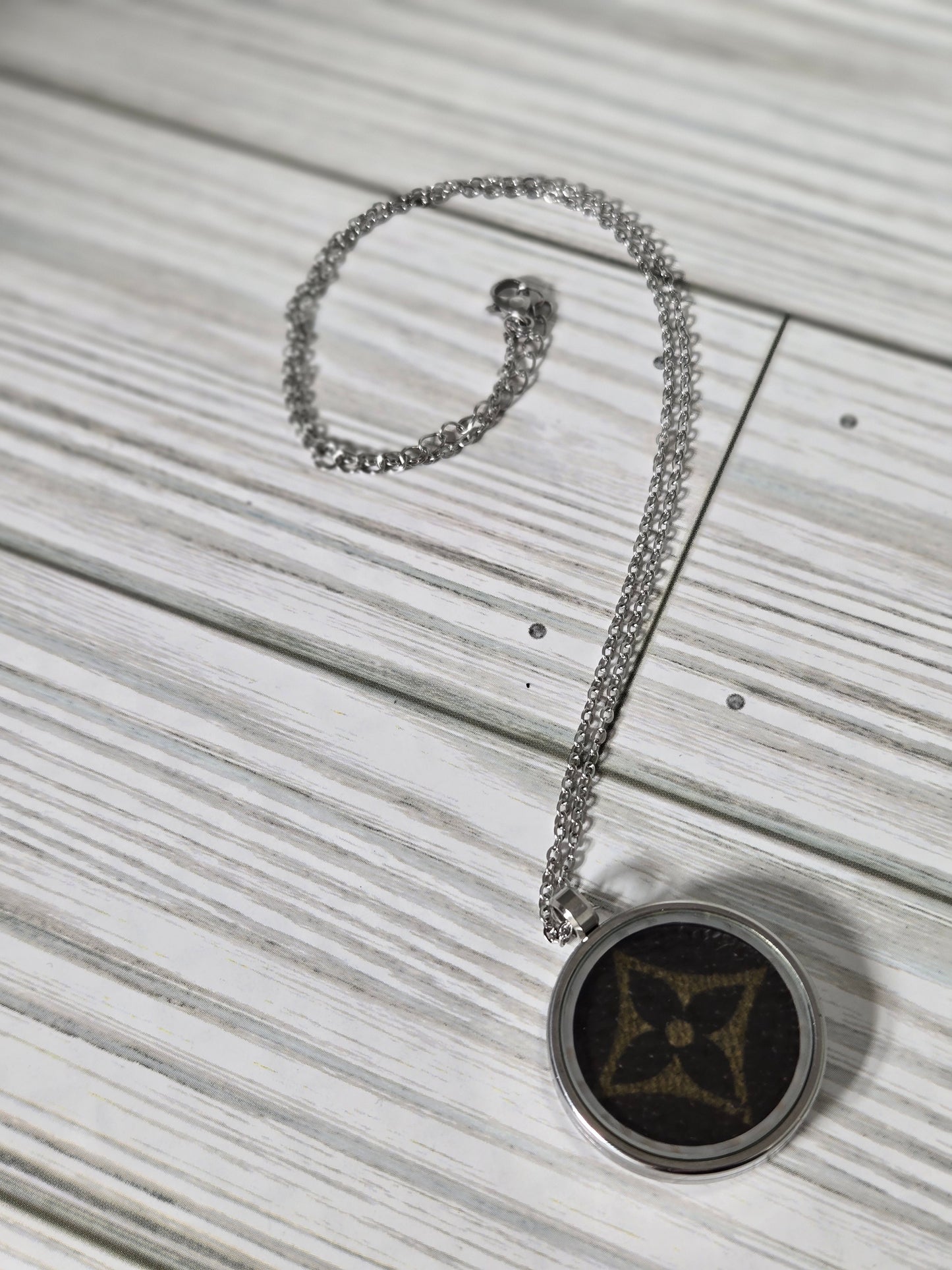 Upcycled stainless steel pendant and chain.