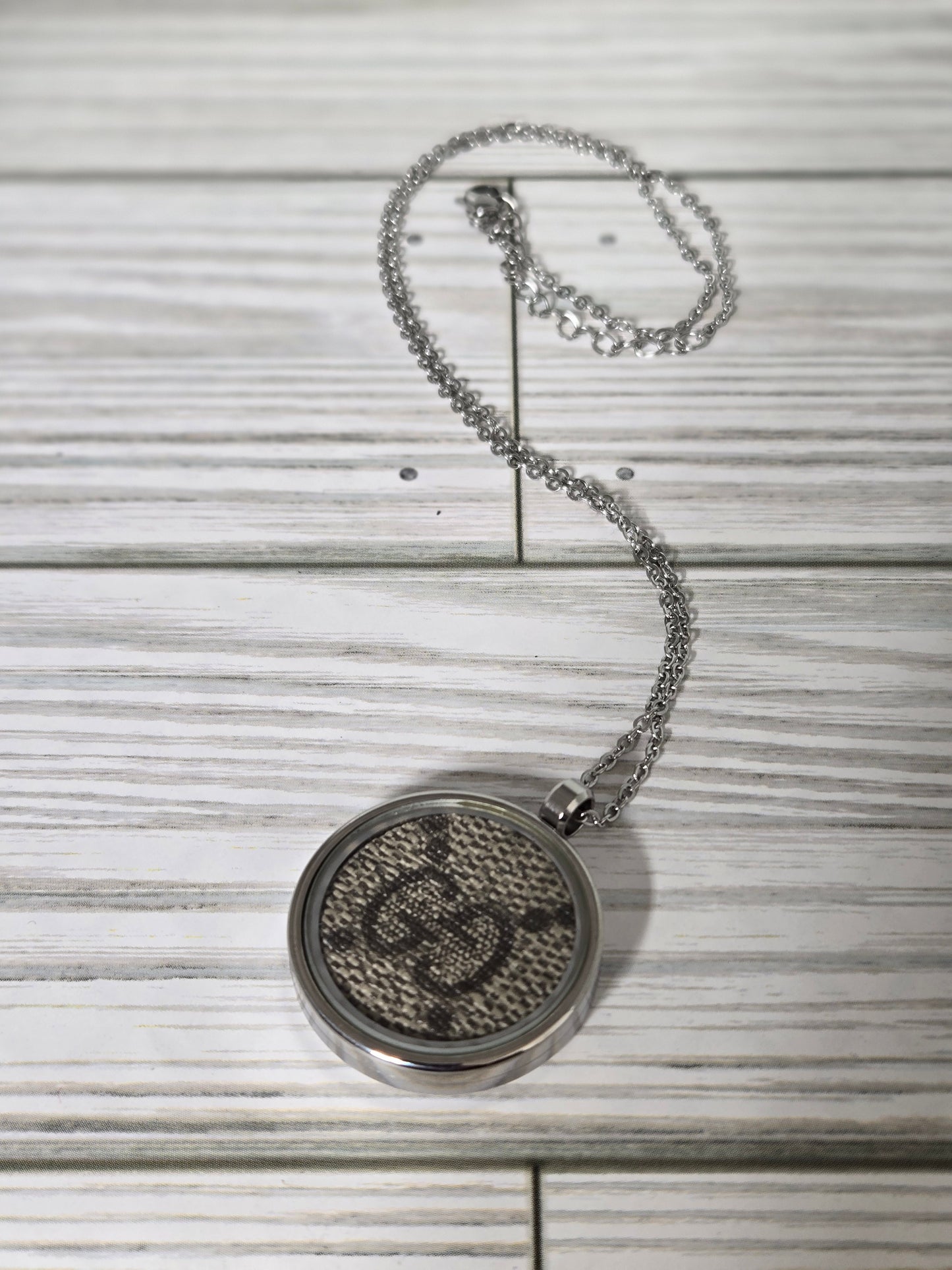 Upcycled stainless steel pendant and chain.