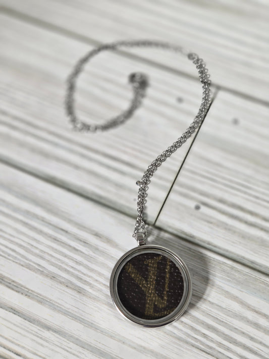 Upcycled stainless steel pendant and chain.