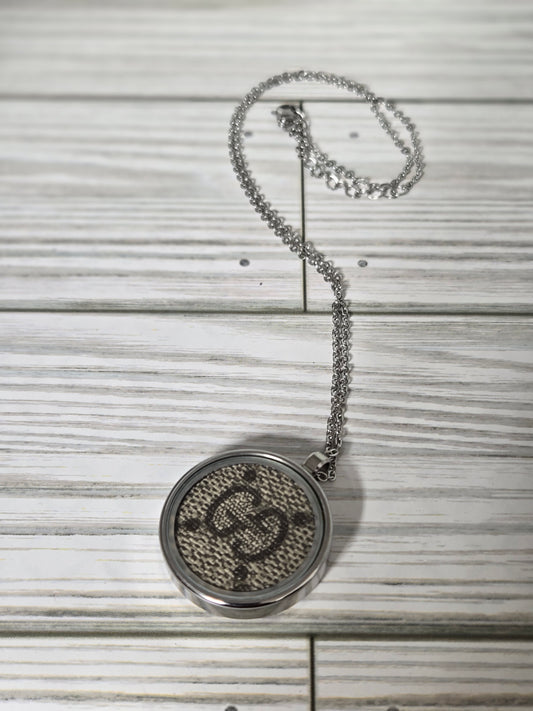 Upcycled stainless steel pendant and chain.