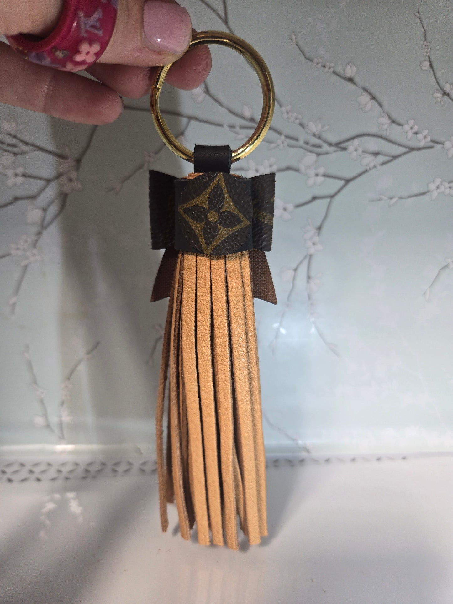 Upcycled leather tassle bow.