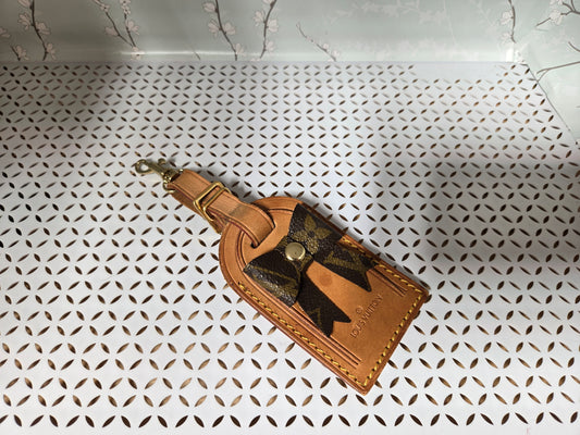 Authentic luggage tag with upcycled bow bag charm.